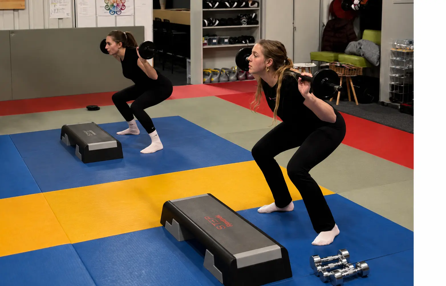 Body Power — techniek eerst, dan kracht Deelnemers voeren squats uit met een halter tijdens Body Power